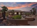 Inviting backyard featuring a cozy seating area, mature trees, and a custom concrete wall at 15774 W Indianola Dr # Six, Goodyear, AZ 85395