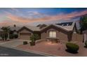 Beautiful single-story home featuring desert landscaping, a garage, and solar panels on the roof at 15774 W Indianola Dr # Six, Goodyear, AZ 85395
