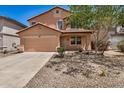 Charming two-story home featuring a two-car garage and low-maintenance desert landscaping at 18475 N Madison Rd, Maricopa, AZ 85139