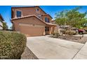 Charming two-story home featuring a two-car garage and low-maintenance desert landscaping at 18475 N Madison Rd, Maricopa, AZ 85139