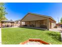 Expansive backyard featuring an artificial lawn, covered patio, gazebo, and hot tub hookups at 1926 S Longspur Ln, Gilbert, AZ 85295