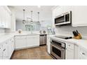 Modern kitchen featuring stainless steel appliances, white cabinets, and stylish countertops for easy cooking at 19475 N Grayhawk Dr # 1128, Scottsdale, AZ 85255