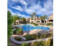 Resort-style pool with lush landscaping, a covered gazebo, and clear blue skies for ultimate relaxation at 19475 N Grayhawk Dr # 1128, Scottsdale, AZ 85255