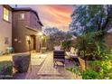 Private backyard with lush landscaping, a stone patio, and comfortable outdoor seating at 21602 N 36Th St, Phoenix, AZ 85050