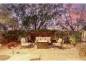 Relaxing backyard patio with comfortable seating and a cozy fire pit under a twilight sky at 21602 N 36Th St, Phoenix, AZ 85050