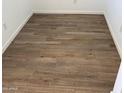 Stylish new flooring featuring light wood-look planks, clean white baseboards, and bright neutral walls at 22368 W Monona Ln, Surprise, AZ 85387