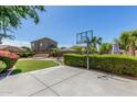 Spacious backyard with a basketball court, manicured hedges, and well-maintained lawn at 2257 E Redwood Ct, Chandler, AZ 85286