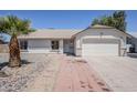 Single story home featuring neutral stucco exterior, desert landscaping and a two-car garage at 2338 E Folley St, Chandler, AZ 85225