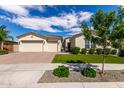 Attractive single-Gathering home with a three-car garage, neat landscaping, and a welcoming desert-style front yard at 25875 S 227Th Way, Queen Creek, AZ 85142