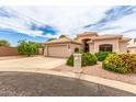 Inviting single-story home featuring desert landscaping, a spacious driveway, and a convenient attached two-car garage at 2926 N 149Th Dr, Goodyear, AZ 85395
