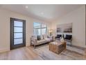 Bright living room with neutral furniture, a light-colored rug, a textured wood coffee table, and contemporary artwork at 3033 N 39Th St # 5, Phoenix, AZ 85018