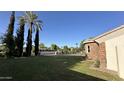 Expansive front yard with lush green grass, mature trees and elegant landscaping at 333 W Bethany Home Rd, Phoenix, AZ 85013