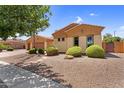 Exterior view of home with well-manicured landscaping and a three car garage at 4204 S Winter Ln, Gilbert, AZ 85297