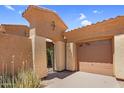 Garage with a private entrance gate in a desert landscape at 4204 S Winter Ln, Gilbert, AZ 85297