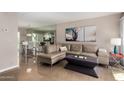 Cozy living room featuring a comfortable sectional sofa, stylish decor, and access to the adjacent dining area at 4600 N 68Th St # 302, Scottsdale, AZ 85251