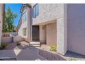 Inviting front entrance with a secure metal gate, desert landscaping, and a well-lit entryway at 480 S Seawynds Blvd, Gilbert, AZ 85233
