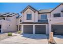 Charming townhome featuring a gray tile roof, a two-car garage, and a well-maintained yard at 480 S Seawynds Blvd, Gilbert, AZ 85233