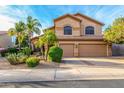 Two-story home featuring a three car garage, desert landscaping and mature palm trees at 4822 E Charleston Ave, Scottsdale, AZ 85254