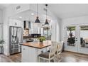 Modern kitchen featuring wood floors, pendant lighting, a wood top kitchen island, and stainless steel appliances at 526 W Kings Ave, Phoenix, AZ 85023