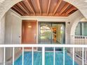 Inviting condo entrance featuring a covered porch and sliding glass door with bright outdoor lighting at 5757 W Eugie Ave # 1076, Glendale, AZ 85304