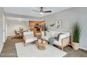 Bright living room features a ceiling fan, modern furnishings, and an open layout to the kitchen at 5757 W Eugie Ave # 1076, Glendale, AZ 85304