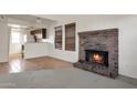 Living room features brick fireplace and tile flooring at 6611 W Kingston Ln, Glendale, AZ 85306