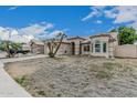 Beautiful curb appeal with a well-manicured lawn and a charming desert landscape at 705 W Country Estates Ave, Gilbert, AZ 85233