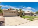 A well maintained house exterior is visible with a two car garage and small palms at 705 W Country Estates Ave, Gilbert, AZ 85233
