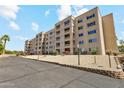 Low exterior angle of condo building showing the balconies and a nicely landscaped front yard at 7840 E Camelback Rd # 110, Scottsdale, AZ 85251