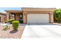 Charming single-story home with a well-manicured front yard with desert landscaping and a two-car garage at 903 E Jacob St, Chandler, AZ 85225