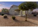 Well maintained backyard with desert landscaping featuring a covered patio and stucco wall at 9303 W Oregon Ave, Glendale, AZ 85305