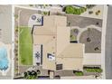 Aerial view of backyard featuring patio, fire pit, manicured lawn and refreshing pool at 9466 E Laurel Ln, Scottsdale, AZ 85260