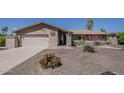 Charming single-story home showcasing attractive landscaping and a convenient two-car garage at 9466 E Laurel Ln, Scottsdale, AZ 85260