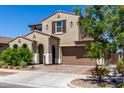 Charming two-story home with a desert landscape, two-car garage and tasteful architectural details at 9548 E Rainbow Ave, Mesa, AZ 85212