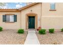 Front entrance showcases a green door, desert landscaping and a well-maintained walkway at 10239 W Via Del Sol -- # 400, Peoria, AZ 85383