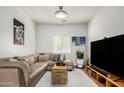 Comfortable living room featuring a large sectional sofa, neutral decor, and entertainment center at 10239 W Via Del Sol -- # 400, Peoria, AZ 85383