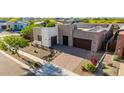 Aerial view of a modern home with desert landscaping, solar panels, and a paver driveway at 1330 E Monte Way, Phoenix, AZ 85042