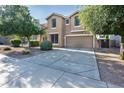Attractive home with manicured landscaping, a spacious driveway, and a welcoming facade at 15028 W Columbine Dr, Surprise, AZ 85379