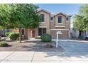 Charming two-story home showcasing a well-maintained front yard and appealing architectural details at 15028 W Columbine Dr, Surprise, AZ 85379