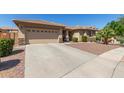 Charming single-story home with two-car garage and low-maintenance desert landscaping at 15288 W Redfield Rd, Surprise, AZ 85379