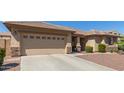 View of home's exterior featuring desert landscaping and two-car garage at 15288 W Redfield Rd, Surprise, AZ 85379