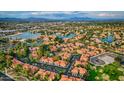 An impressive aerial view showcases the property amidst a well-maintained community with mature trees and water features at 1633 E Lakeside Dr # 98, Gilbert, AZ 85234
