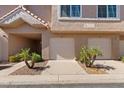 Front exterior showcasing the unit's garage with a lovely facade and low-maintenance landscaping at 1633 E Lakeside Dr # 98, Gilbert, AZ 85234
