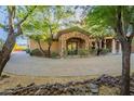 Beautiful home showcasing stone accents, a charming entryway, and a circular paver driveway at 16716 S 32Nd Ln, Phoenix, AZ 85045