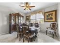 Classic dining room with a large wooden table, ornate china cabinet, and elegant decor for formal gatherings at 1749 W Posada St, Coolidge, AZ 85128