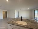 Open floorplan featuring neutral walls and tile flooring connecting the kitchen, dining area and living spaces at 20615 N 226Th Dr, Surprise, AZ 85387