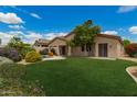 Expansive backyard with lush green grass, mature trees, and a sparkling pool at 22322 N 77Th St, Scottsdale, AZ 85255