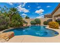 Beautiful pool surrounded by lush landscaping creating a private backyard oasis at 22322 N 77Th St, Scottsdale, AZ 85255