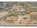 Aerial view of a rural area featuring dirt lots, homes, and sparse vegetation at 22819 E Ray Rd, Mesa, AZ 85212