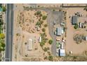 Bird's-eye perspective of land with a home and outbuildings, showing the property's setup and the open desert environment at 22819 E Ray Rd, Mesa, AZ 85212